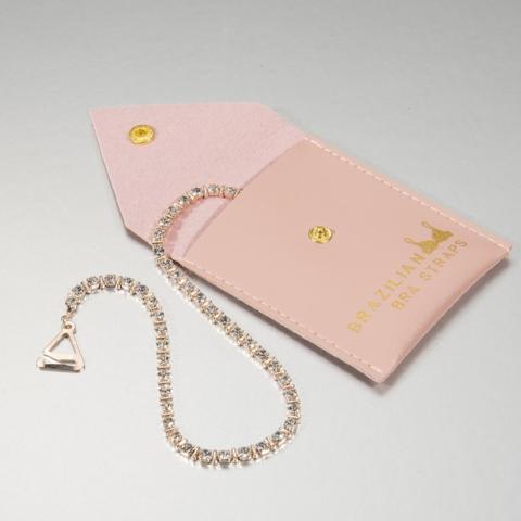rose gold plated bra straps with crystals in a pink pouch