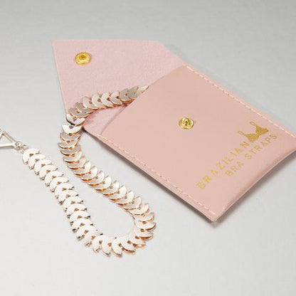 pink shiny bra straps on a pink gift pouch